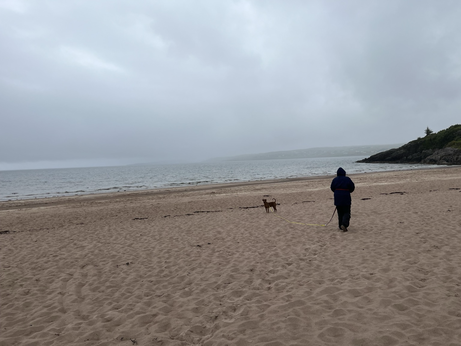 Gairloch beach with the cloud down. Wife and dog in the foreground. 